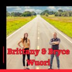 Photo of podcast guests Brittany and Bryce Wuori standing on a two-lane blacktop road.